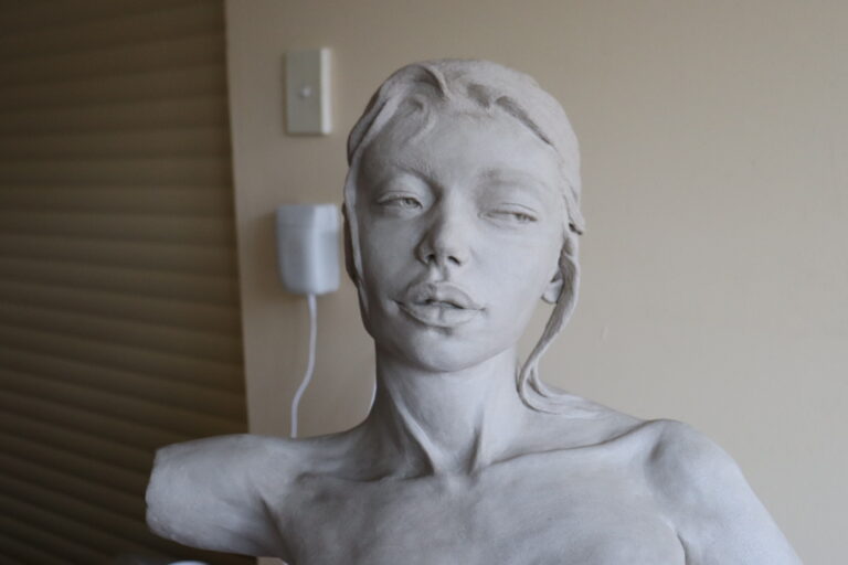 a ceramic sculpture depicting a nude female